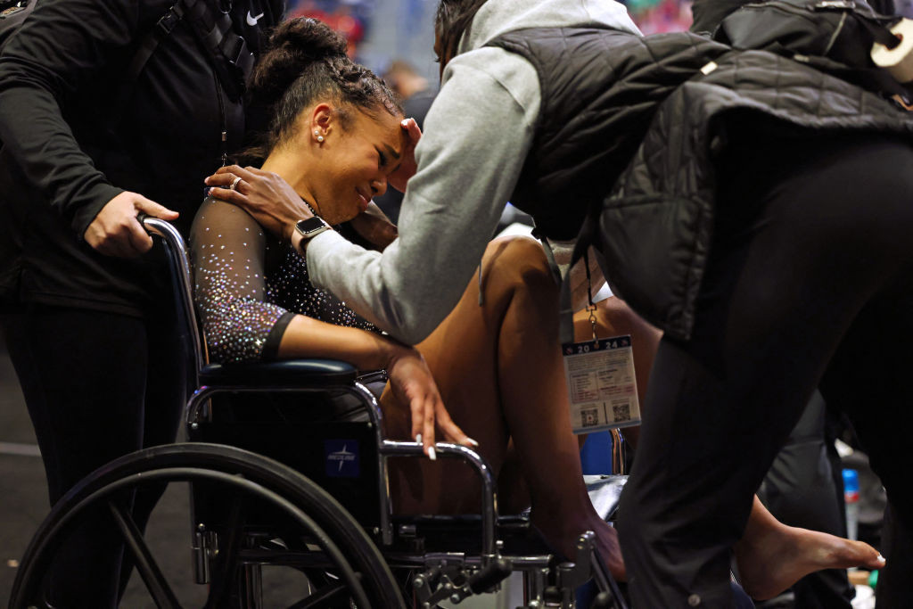Konnor McClain in tears as she leaves the Core Hydration Classic in a wheelchair after injuring her Achilles. GETTY IMAGES