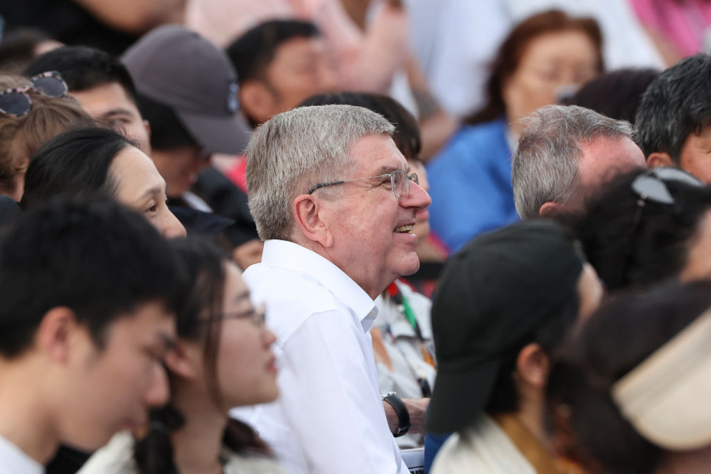 IOC President Thomas Bach enjoys with fellow spectators in the inaugural Olympic Qualifier Series in Shanghai. GETTY IMAGES
