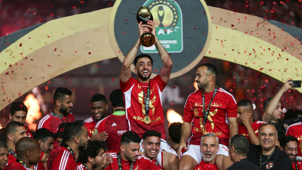 Ahly players celebrate with the winner's trophy after winning the second leg of the CAF Champions League final. GETTY IMAGES
