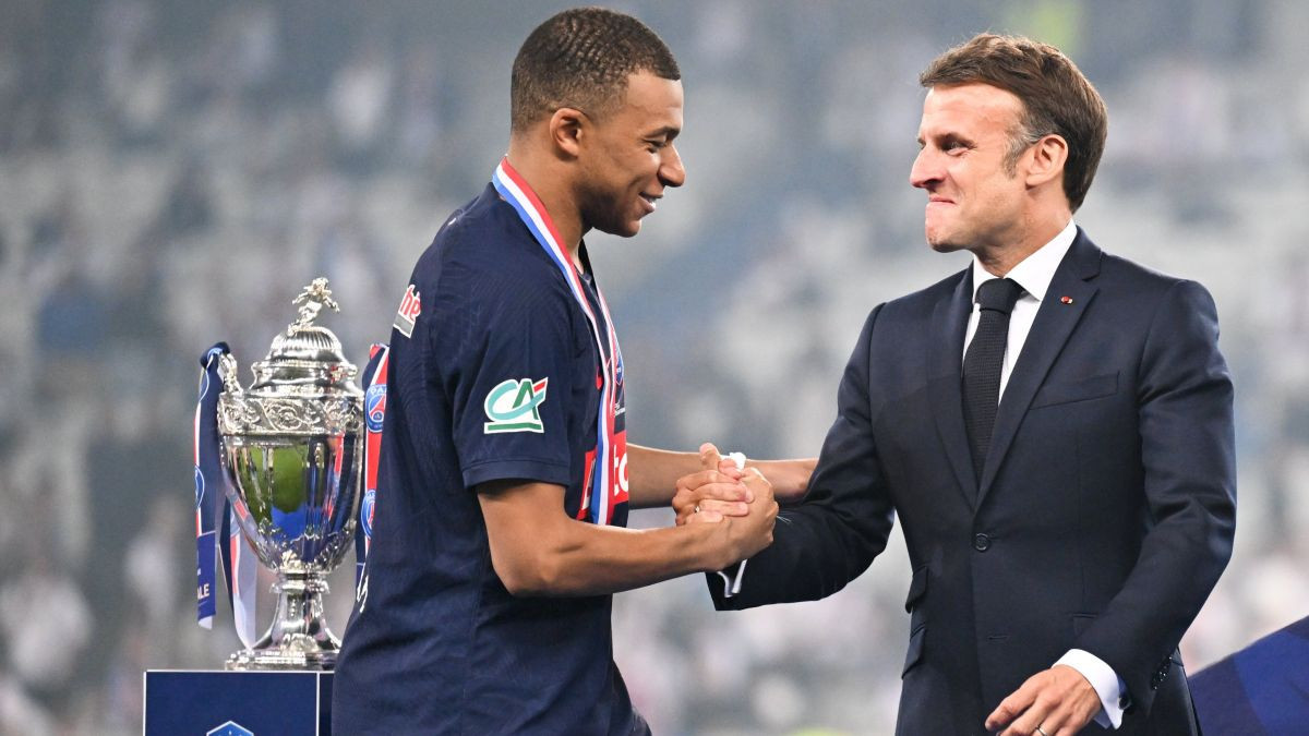 Macron congratulates Kylian Mbappe on the podium after winning the French Cup Final. GETTY IMAGES 