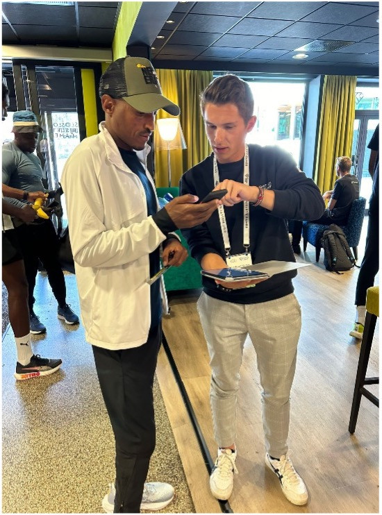 AIU Education Officer Jan Steinmueller (R) helps Ethiopian runner Hagos Gebrhiwet register for an AIU Call Room session. AIU