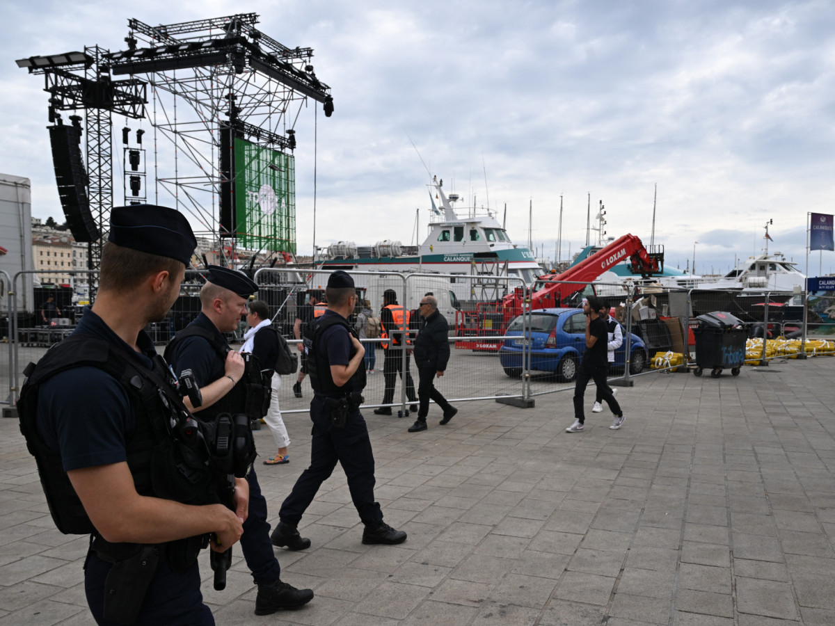 Police officers patrol the Marseille port, before the arrival of the Olympic torch. GETTY IMAGES