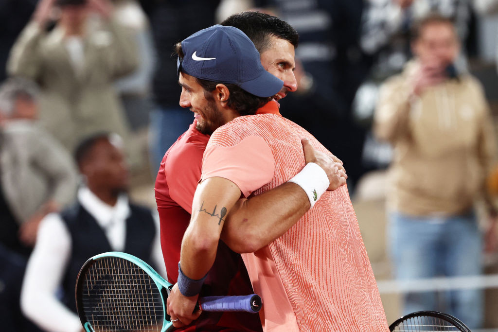 Novak Djokovic embraces Lorenzo Musetti after winning the men's singles match. GETTY IMAGES