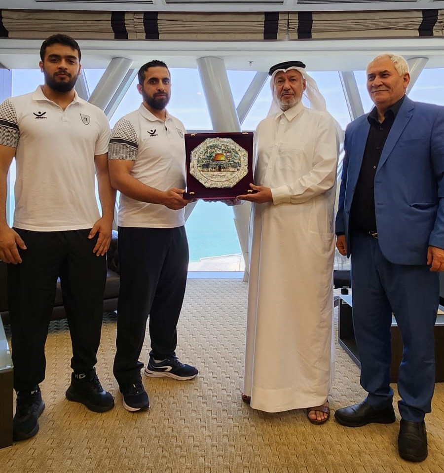 Mohammed Hamada (L) his coach, Mohamed Al Mana (Qatar Weightlifting Federation) and Mohammed Jalood (IWF President). IWF