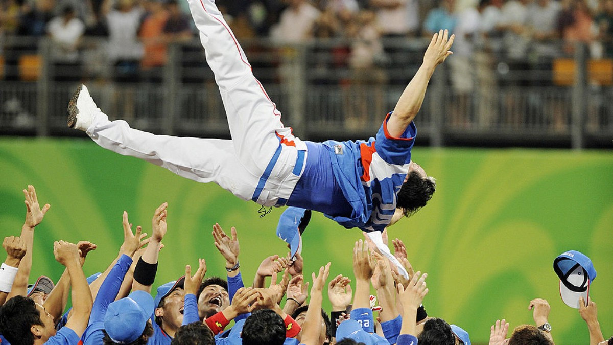 Kim Kyung-moon flies to embrace his players after winning gold at Beijing 2008. GETTY IMAGES