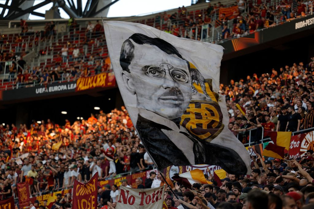 AS Roma supporters wave a flag, bearing the portrait of the team founder Italo Foschi. GETTY IMAGES