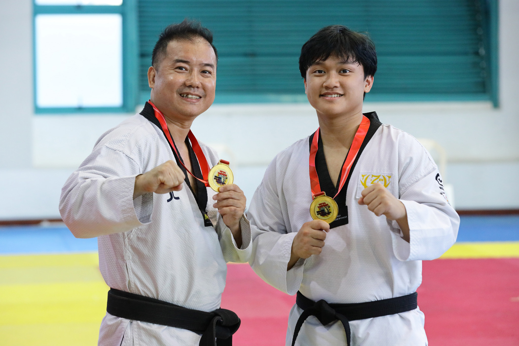 Brian Peh (left) and Justin Peh with their gold medals. FCPR
