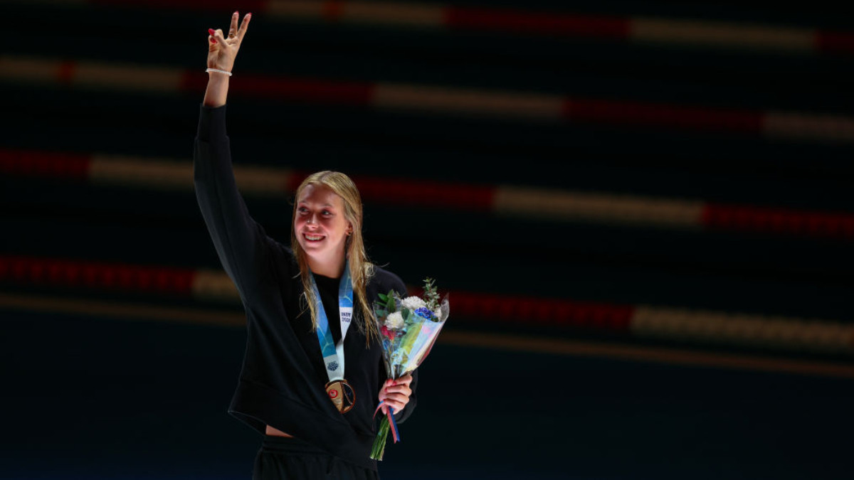 Gretchen Walsh reacts while accepting her gold medal for winning the Women's 100 Meter Butterfly Championship in 2024 U.S. Olympic Team Swimming Trials  GETTY IMAGES 
