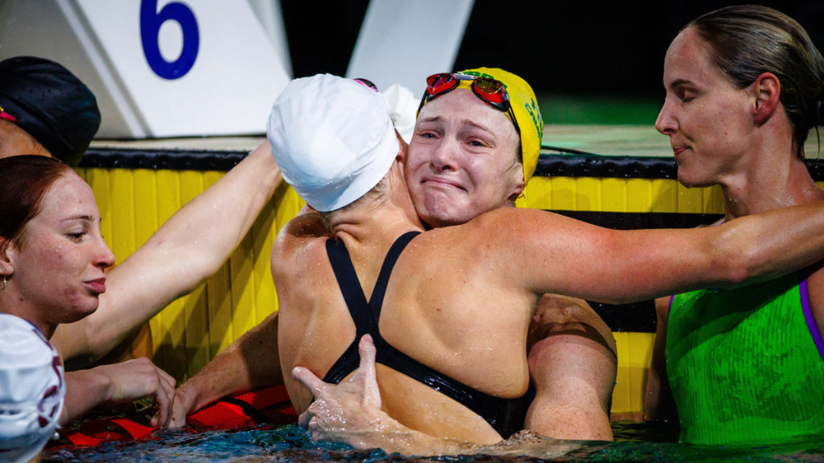 Cate Campbell sheds a tear as she is embraced by her fellow competitor's following the women's 50m freestyle final during the Australian Swimming Trials . GETTY IMAGES