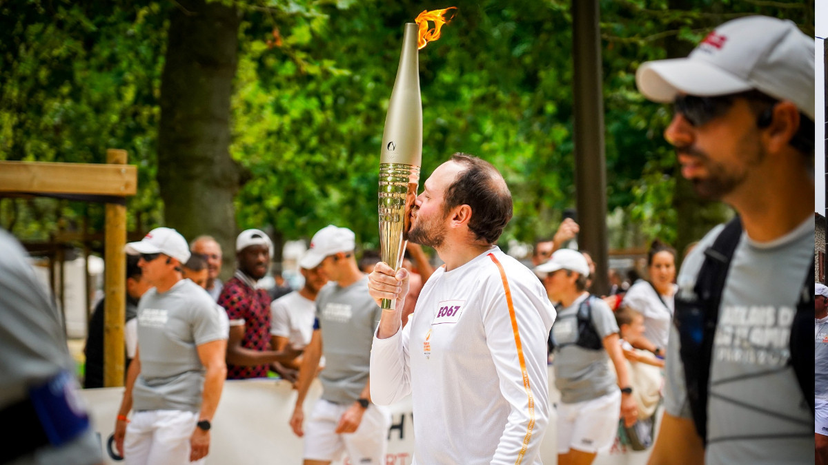 Théo Curin kisses the Olympic Torch in a very touching moment. VILLE DE VICHY