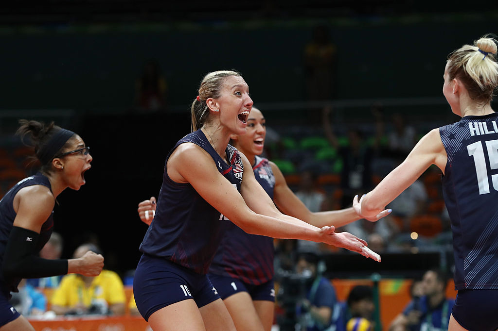 Larson celebrating with the US Volleyball tea, after winning a match. GETTY IMAGES