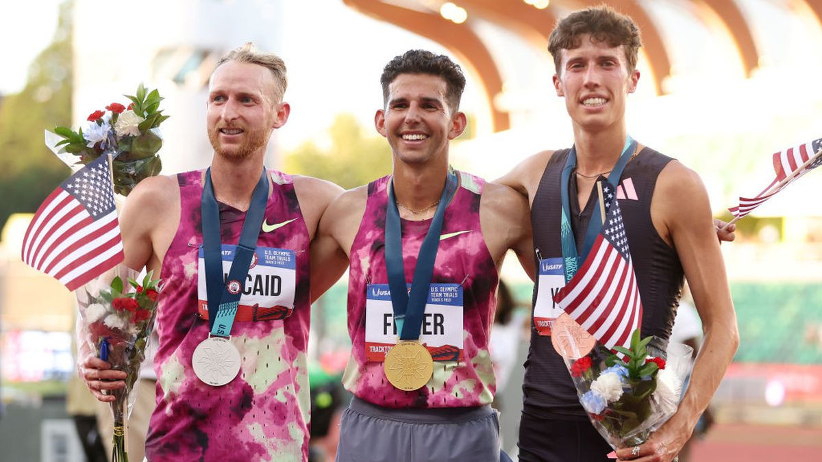 Woody Kincaid, second place, Grant Fisher, first place, and Nicolas Young, third place, pose on the podium after the men's 10,000 metre. GETTY IMAGES