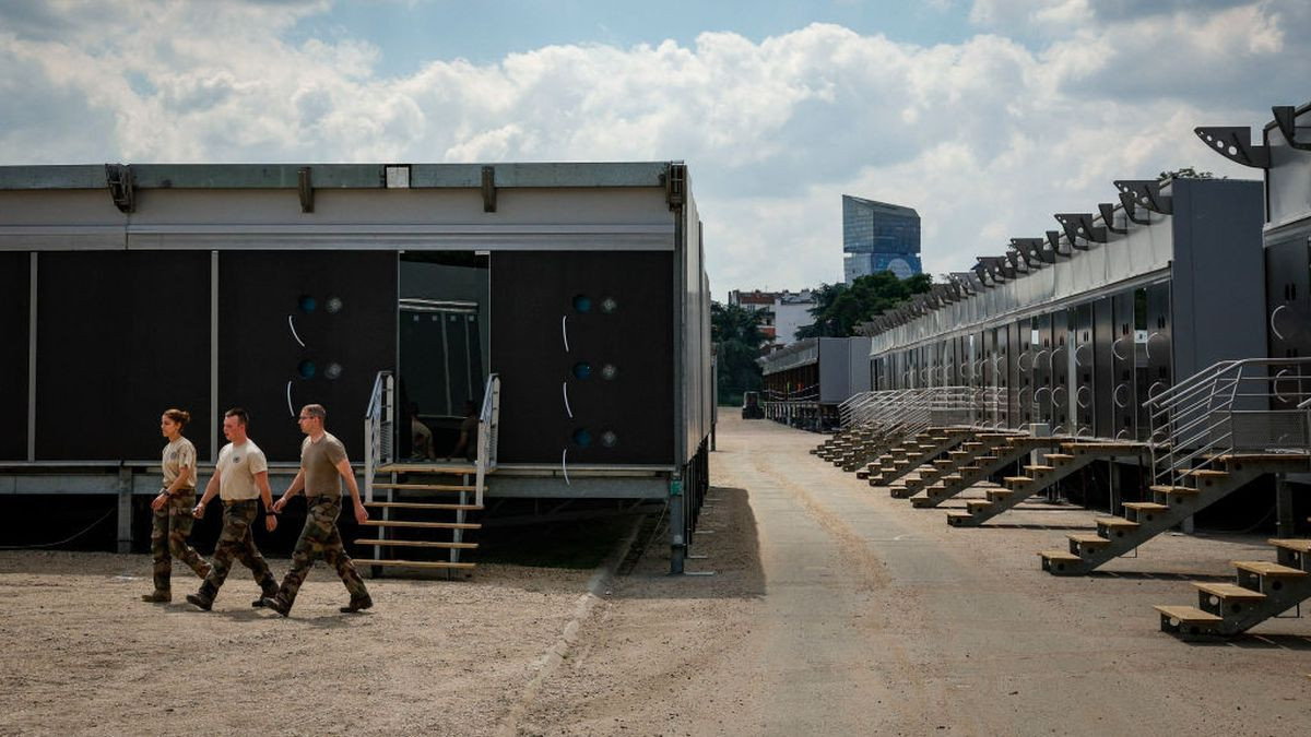 Army personnel walk past temporary barracks installed at the Pelouse de Reuilly area to house the approximately 5,000 soldiers in Paris 2024. GETTY IMAGES
