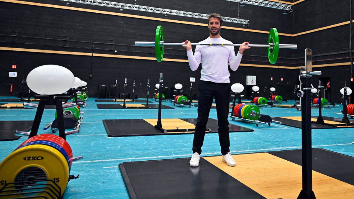 Tony Estanguet lifts a weight bar inside the gym during the media visit of Paris 2024 Olympic and Paralympic village on July 02, 2024 in Paris. GETTY IMAGES