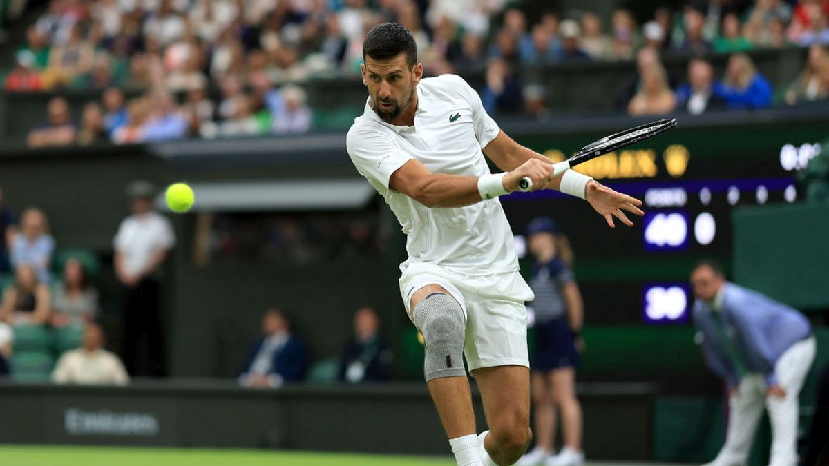 Novak Djokovic of Serbia plays a backhand against Vit Kopriva of Czechia in his Gentlemen's Singles first round match during day two of The Championships Wimbledon 2024 - Getty Images
