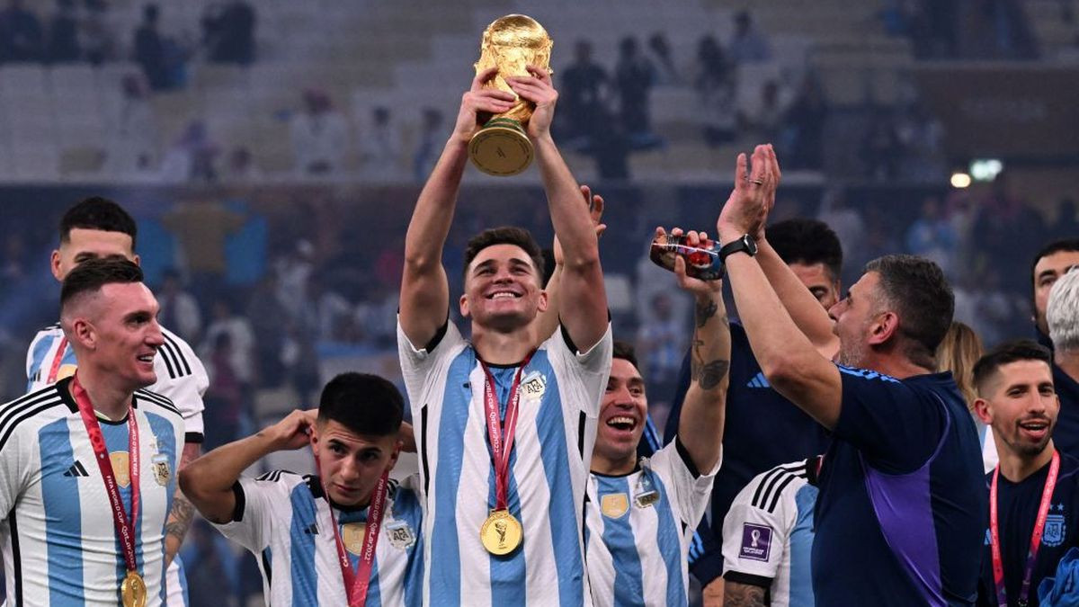Argentina's forward #09 Julian Alvarez lifts the FIFA World Cup Trophy as he celebrates with teammates winning the Qatar 2022 World Cup at Lusail Stadium. GETTY IMAGES