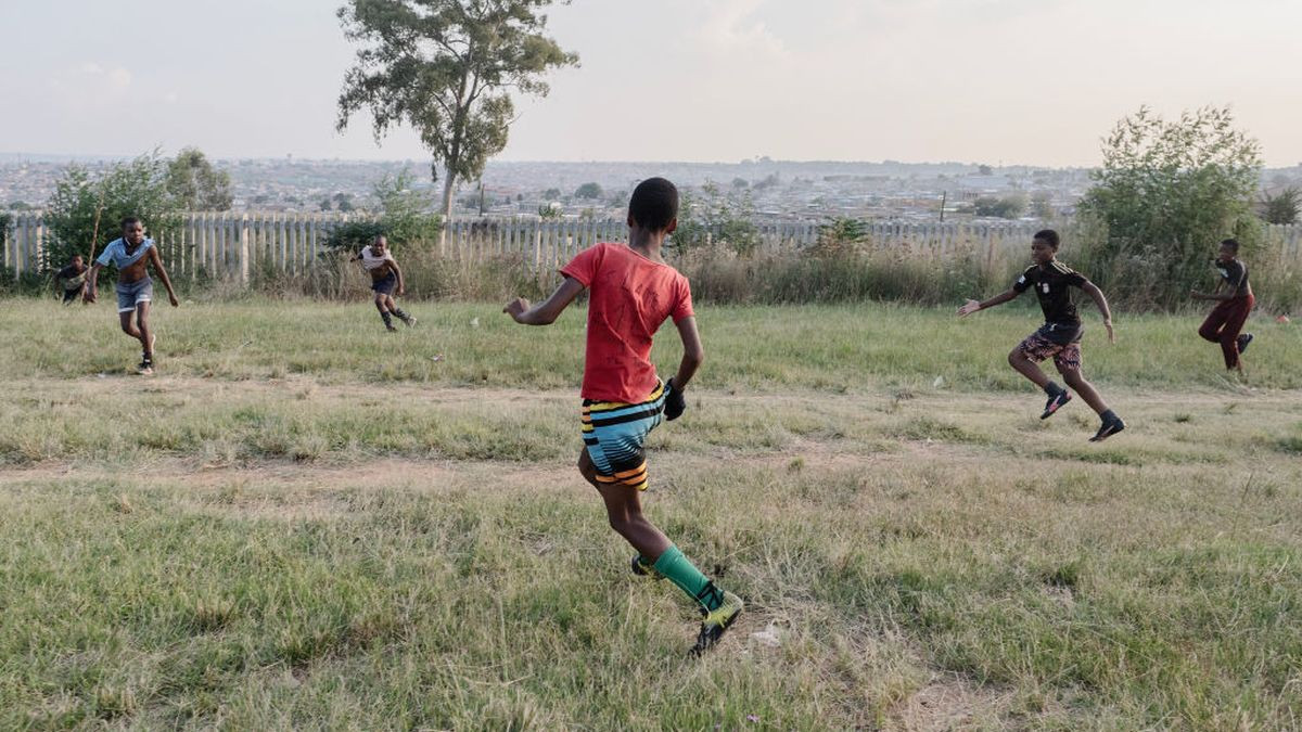 Young soccer enthusiasts playing with the local informal football team - Getty Images