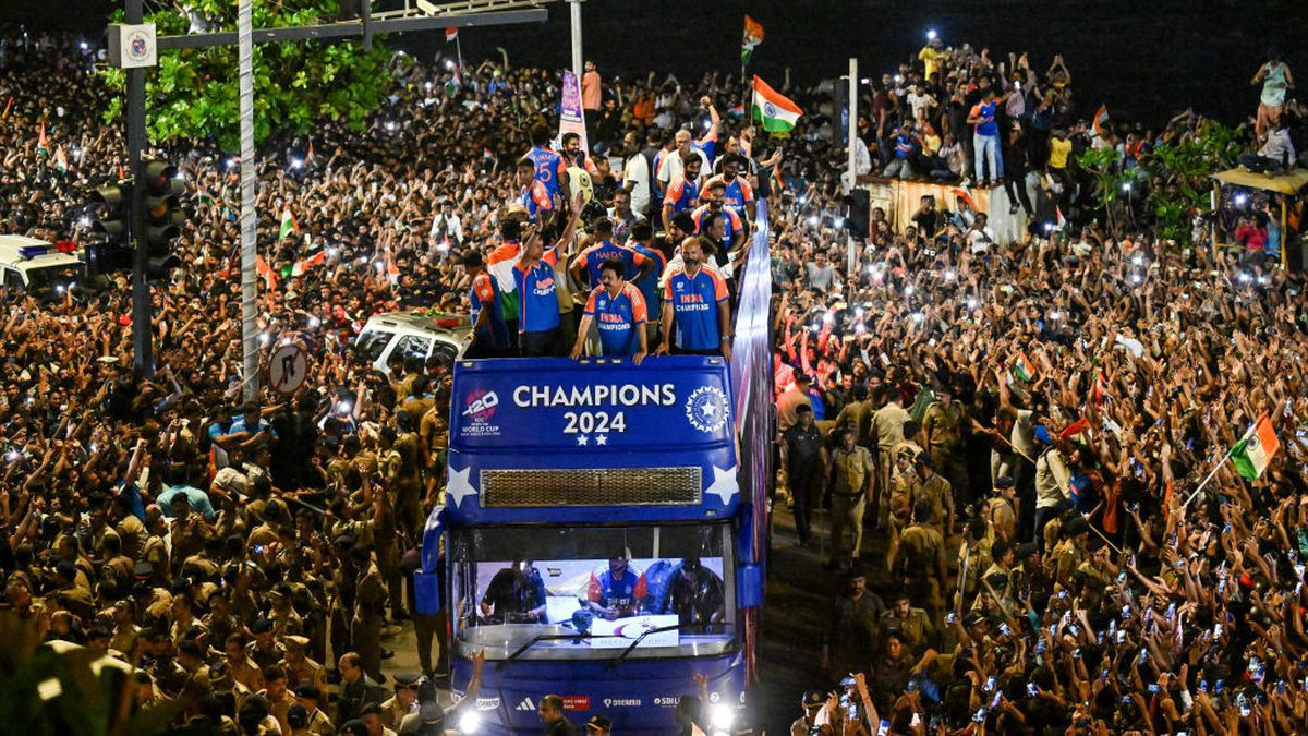 Indian cricketers gesture during an open bus roadshow upon their arrival in Mumbai on 4 July 2024, after winning Ty20 World Cup in Barbados. GETTY IMAGES