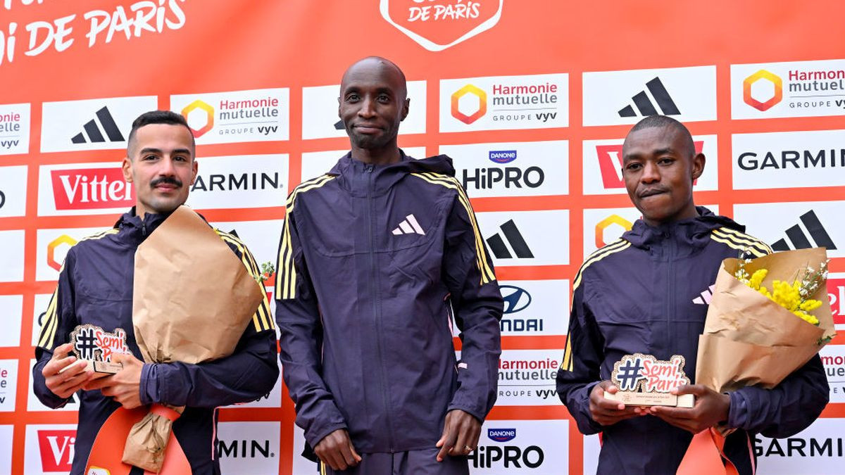 Mehdi Frere of France, Bernard Koech of Kenya and Jorum Okombo of Kenya pose on the podium after the Paris half marathon. GETTY IMAGES.
