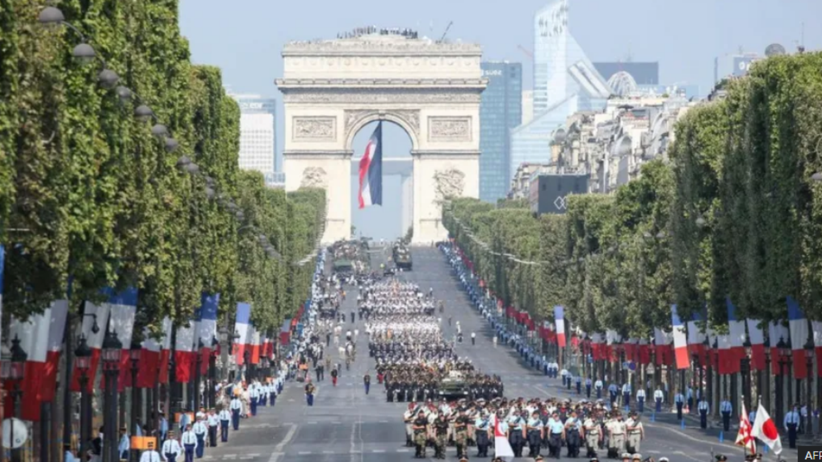 France celebrates National Day with Olympic Torch amid political crisis
