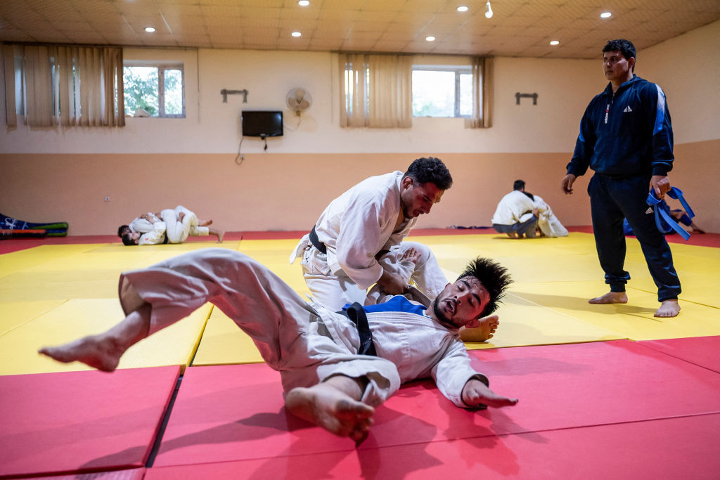 Mohammad Samim Faizad (top) takes part in a training session with fellow judoka in Kabul. GETTY IMAGES