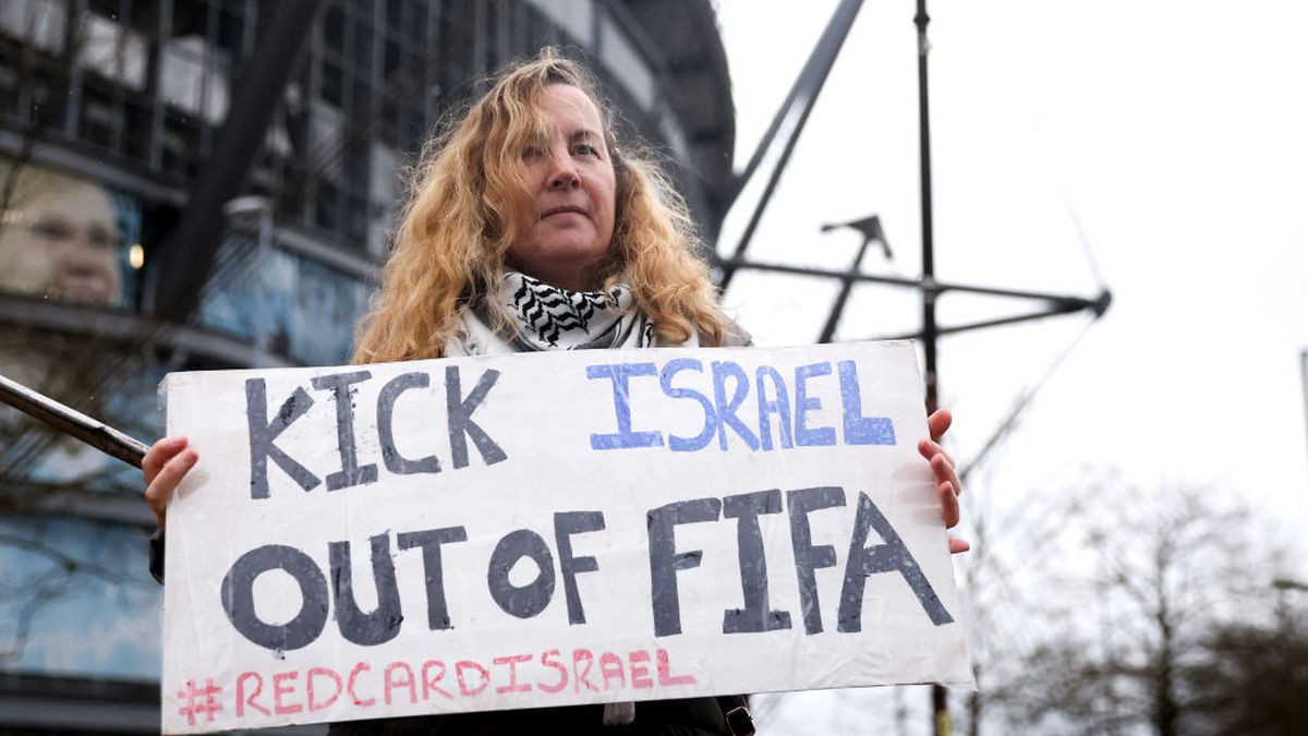 A fan holding a banner against Israel and FIFA. GETTY IMAGES