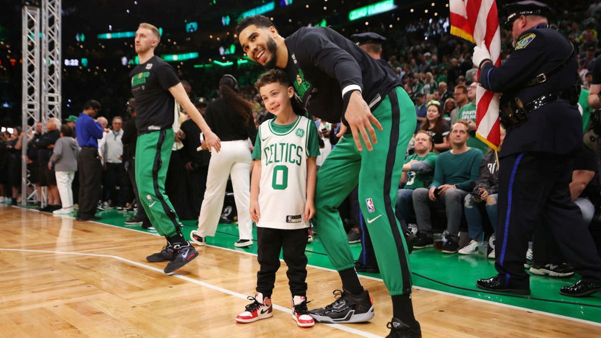 Celtics' Tatum poses with his son Deuce for a photo at an NBA pregame. GETTY IMAGES