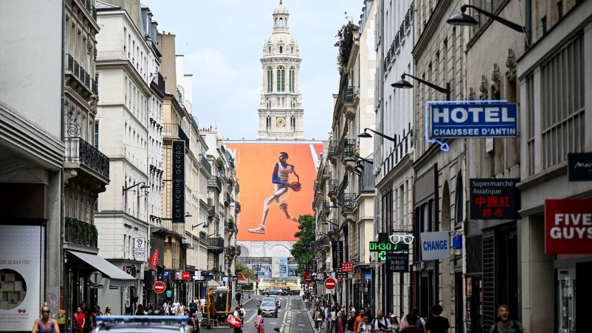 An advertising banner depicts France's basketball player Victor Wembanyama on a street. GETTY IMAGES