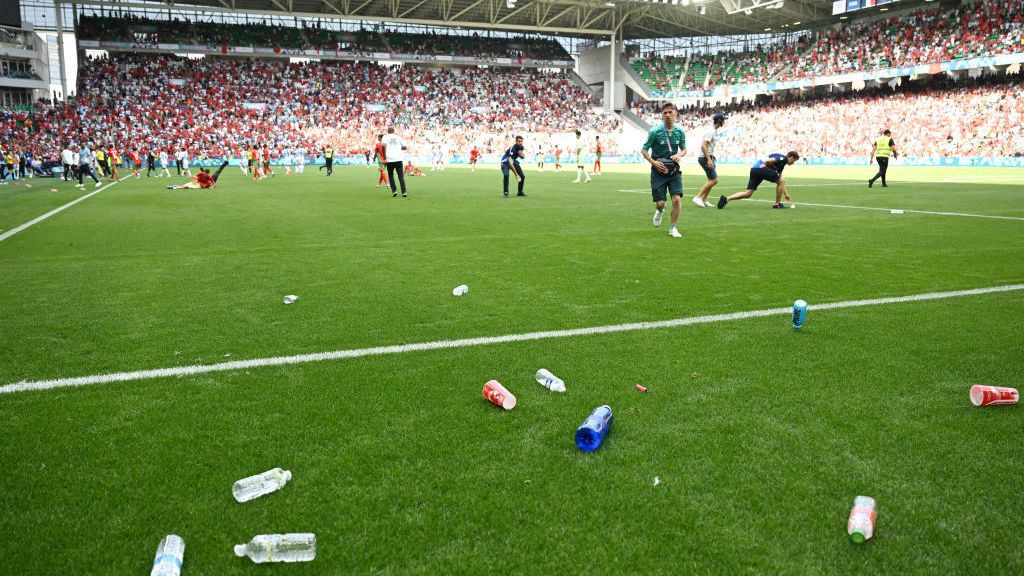 Remove bottles from the pitch thrown from the stands during the Men's group B match between Argentina and Morocco during the Olympic Games Paris 2024