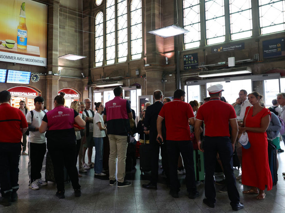 Employees of SNCF railway company speak to passengers at the Strasbourg train station in Strasbourg on July 26, 2024 as France's high-speed rail network was hit by malicious acts. GETTY IMAGES