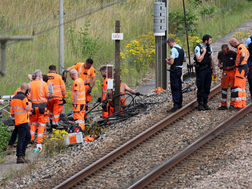 SNCF employees and French gendarmes inspect the scene of a suspected attack on the high speed railway network. GETTY IMAGES