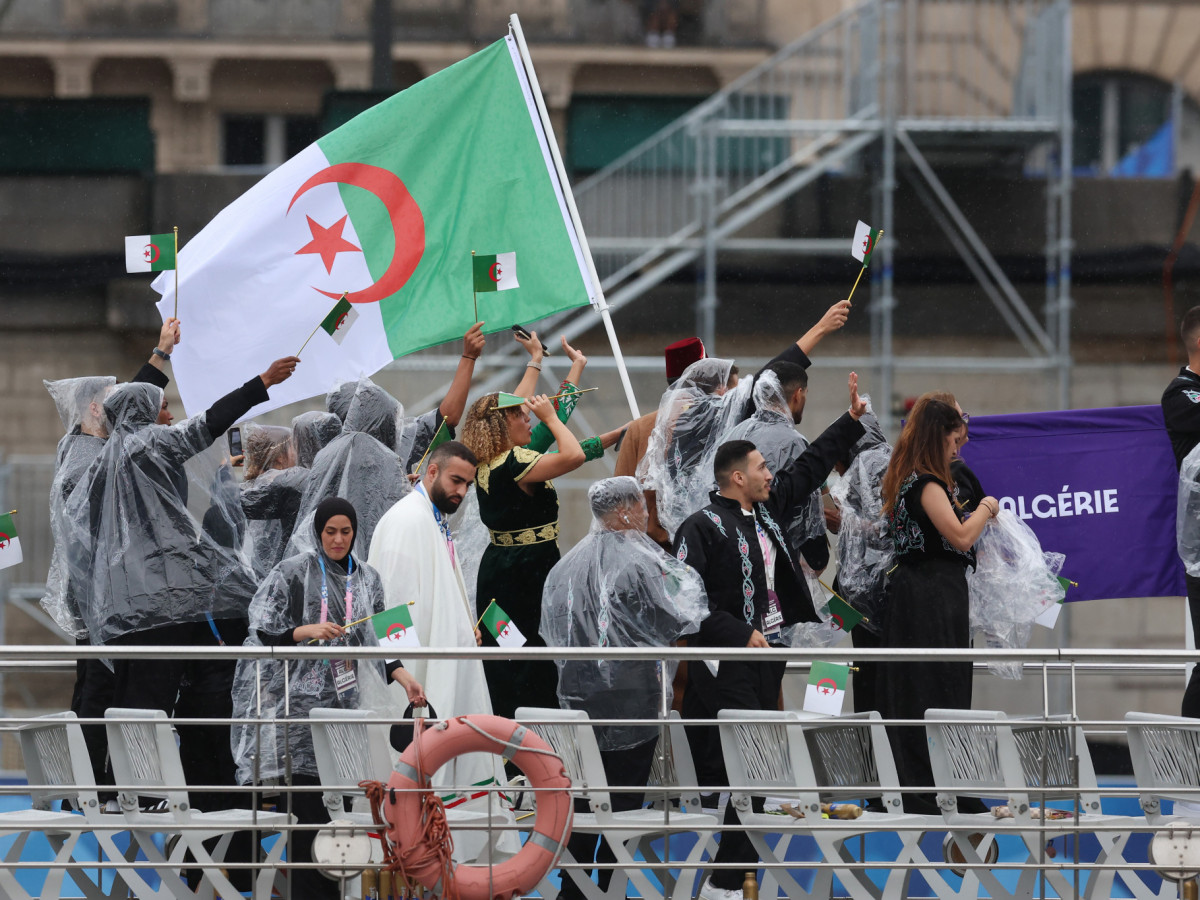 Members of the Algerian delegation tossed roses into the River Seine. GETTY IMAGES