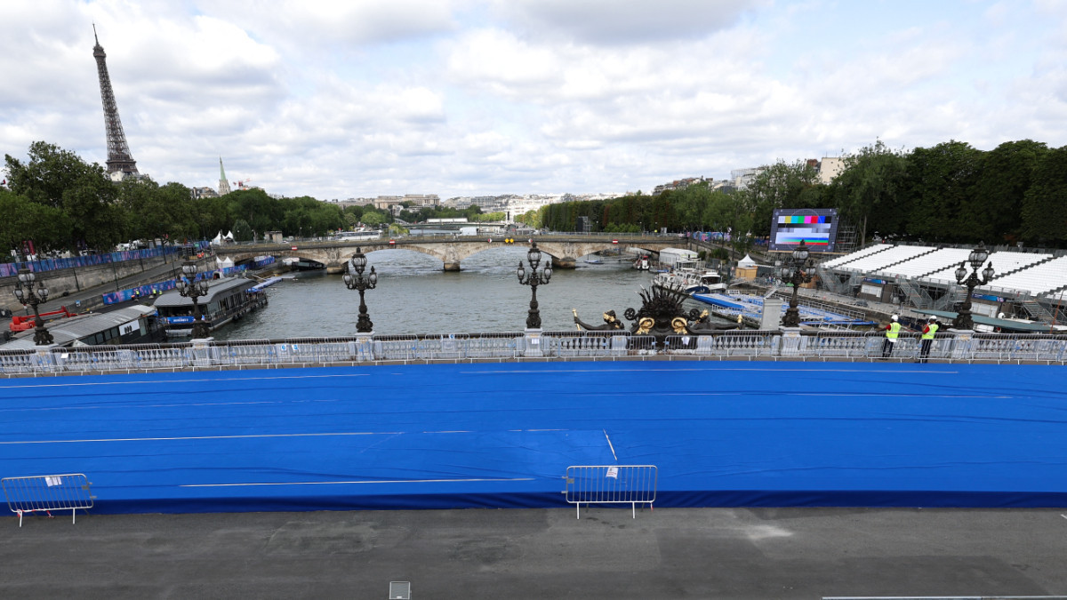 An employee of the Paris 2024 works to set up of the triathlon piste on the Alexandre III bridge. GETTY IMAGES