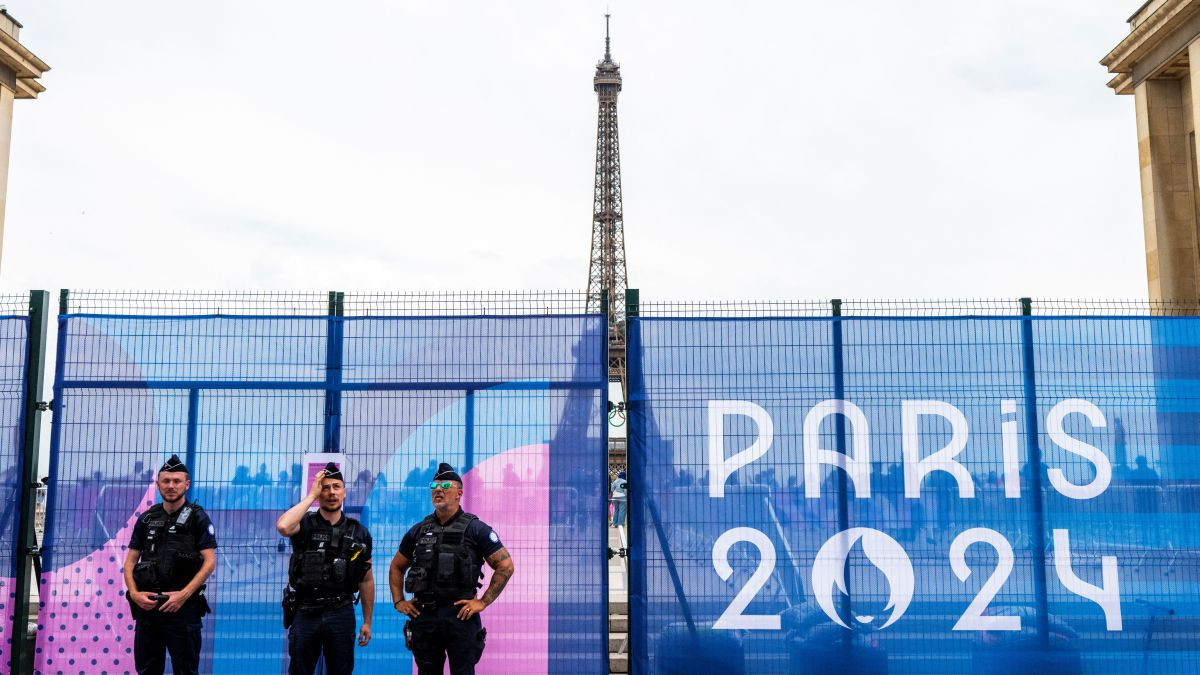 French Gendarmerie officers stand guard in front of a security fence adorned with a Paris 2024 Olympic Games banner at the Trocadero Esplanade near the Eiffel Tower. GETTY IMAGES