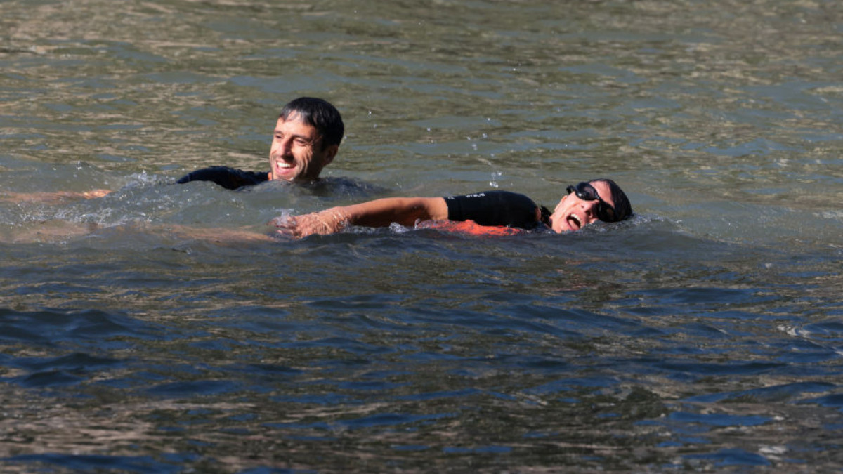 Paris Mayor Anne Hidalgo and Tony Estanguet swim in the Seine, in Paris on 17 July 2024. GETTY IMAGES