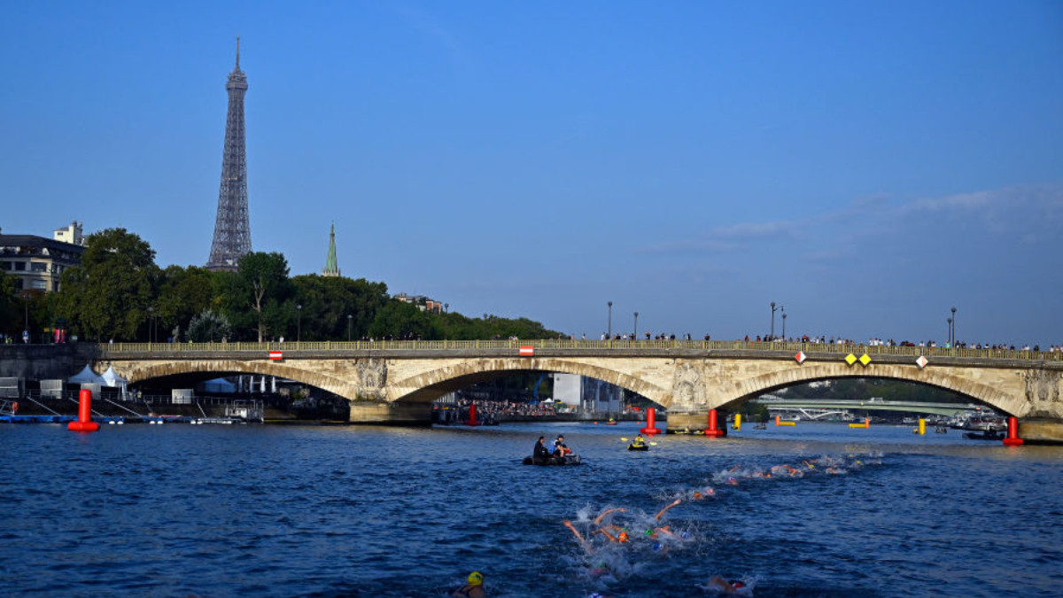 Athletes swim in the Seine River in front of the Eiffel Tower, before the Women’s World Triathlon was suspended in August 2023. GETTY IMAGES