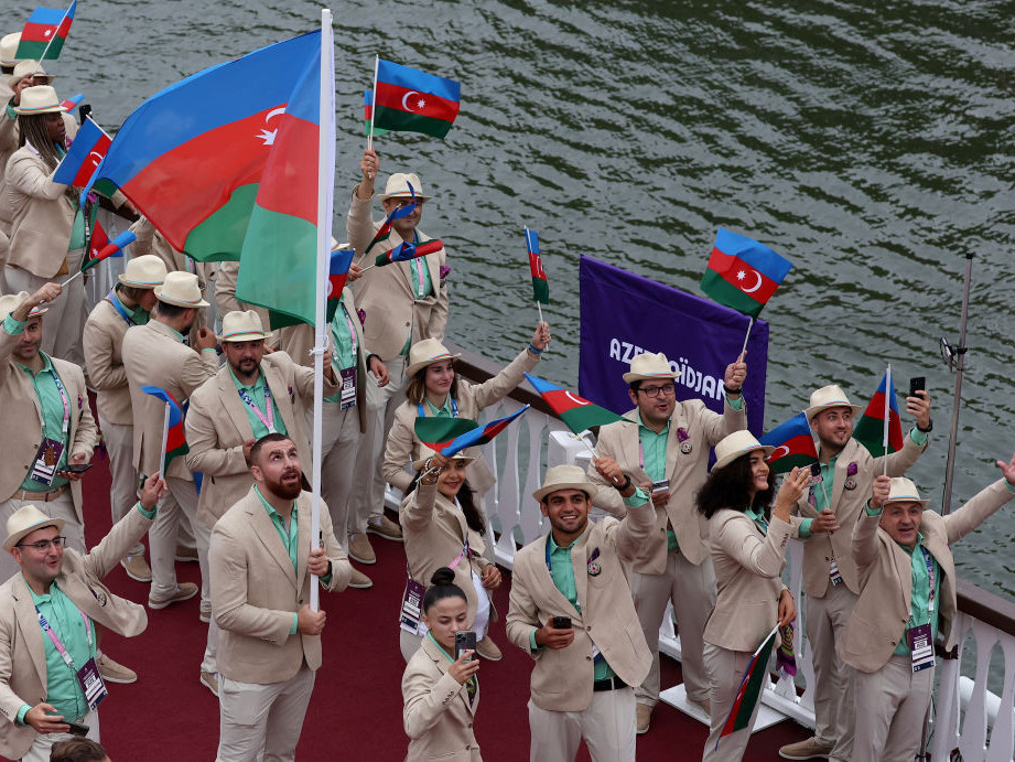 Team Azerbaijan proudly waves their flag on the team boat along the river seine during the opening ceremony. GETTY IMAGES