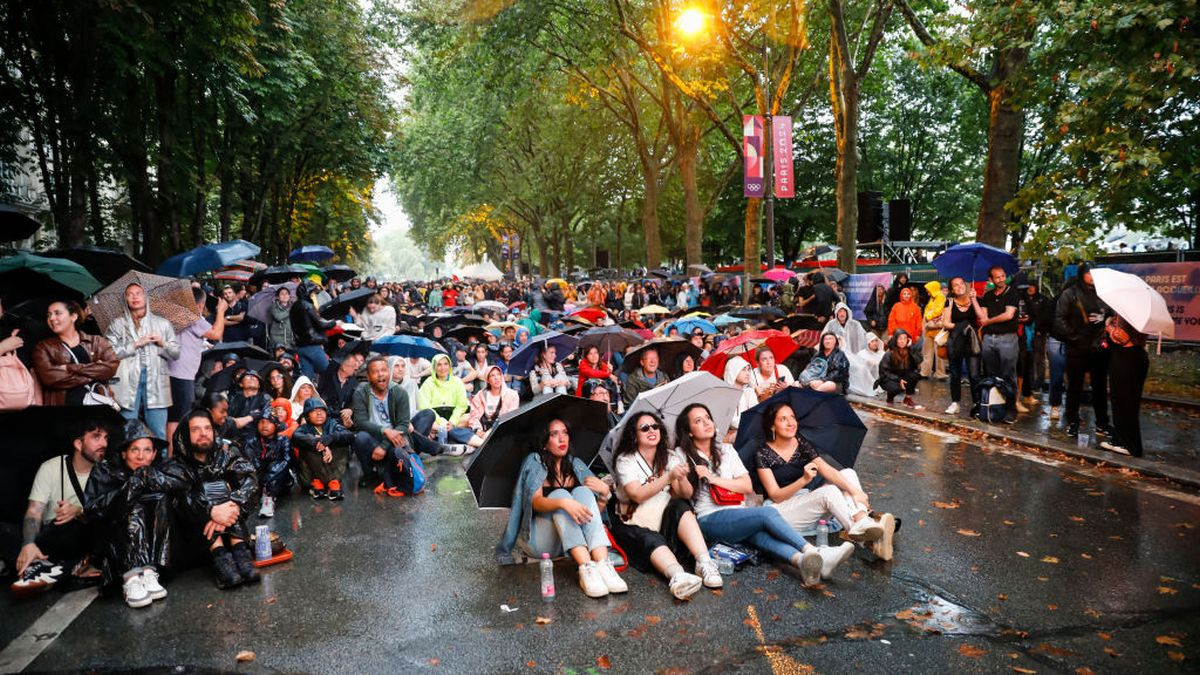 Parisians and tourists watch the opening ceremony under the rain GETTY IMAGES