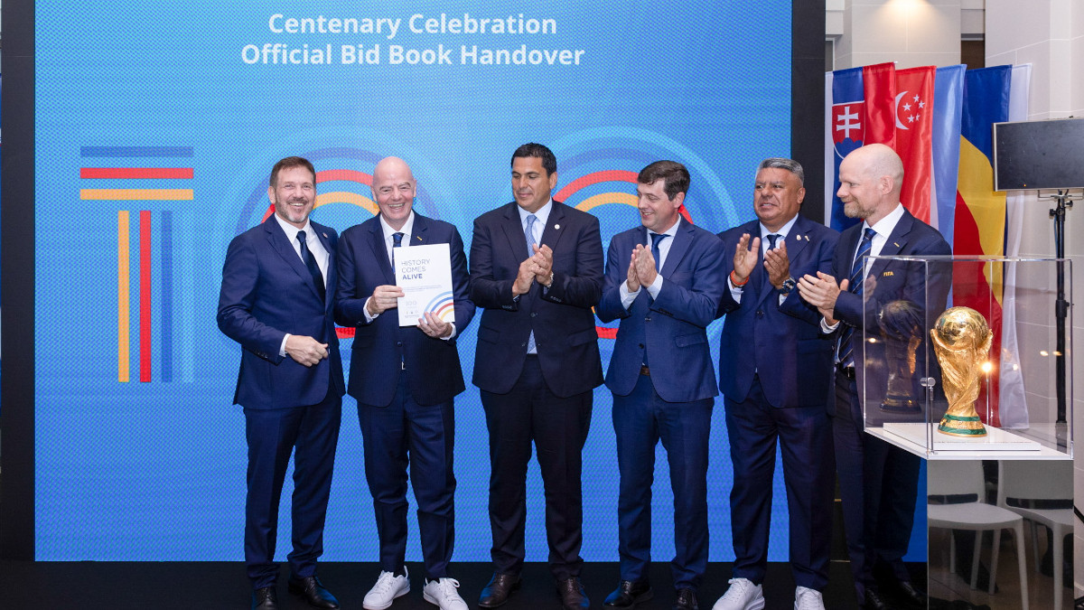 Gianni Infantino and Mattias Grafström receive the Centenary Celebration Official Bid Book at FIFA's Paris office on 29 July. RIDET/FIFA