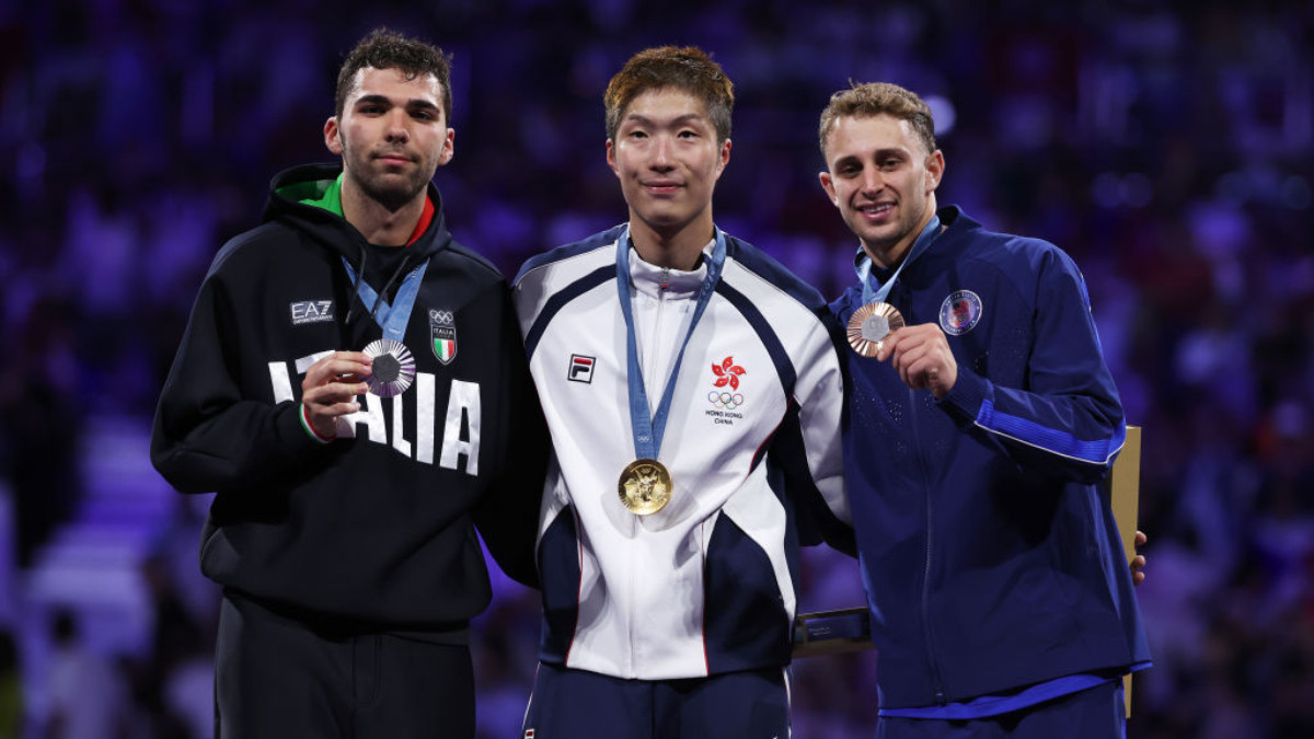 Ka Long Cheung, Filippo Macchi and Nick Itkin celebrate on the podium during the Men's Foil Individual medal ceremony. GETTY IMAGES
