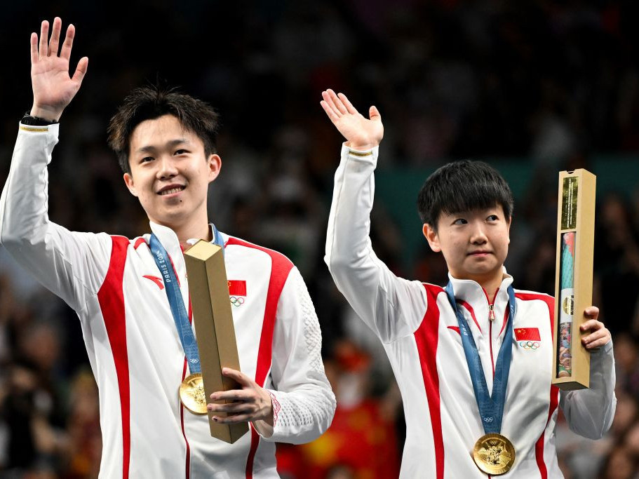 Gold medallists Wang Chuqin and Sun Yingsha celebrate their mixed doubles gold. GETTY IMAGES