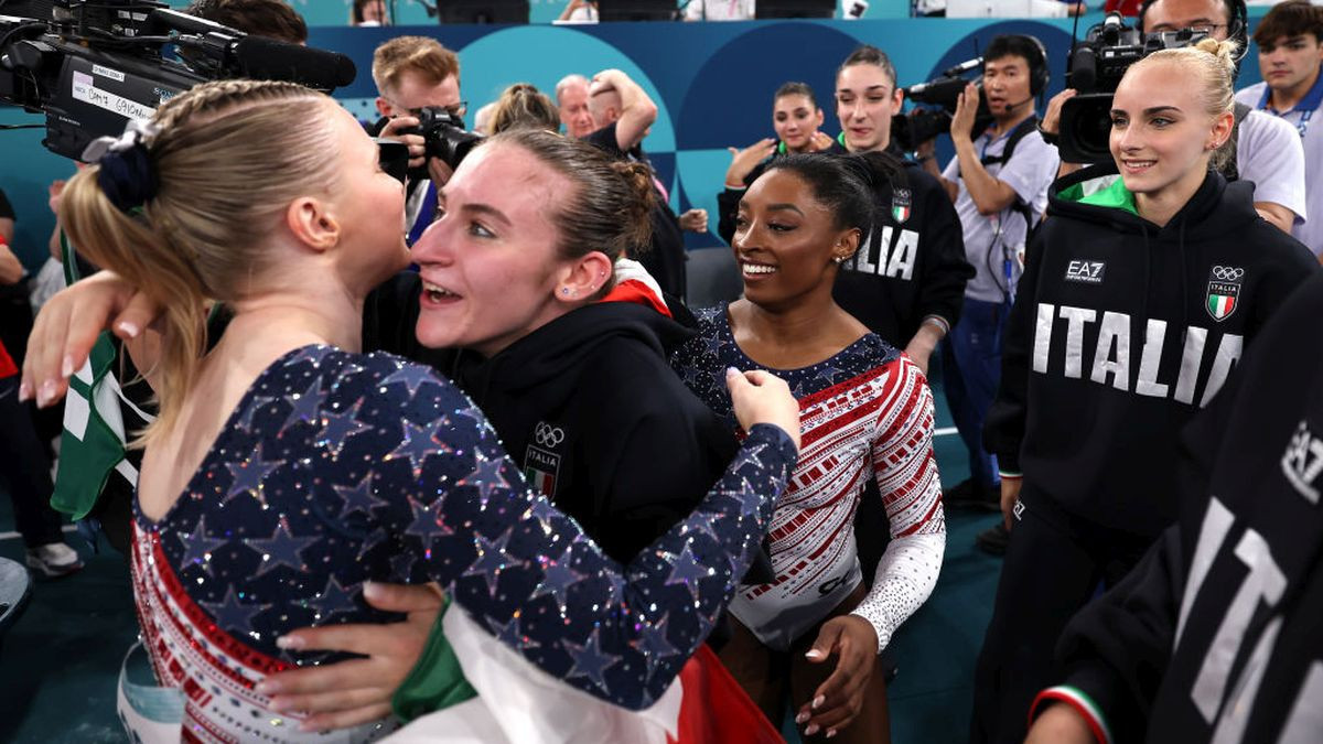Angela Andreoli of Team Italy congratulates Jade Carey and Simone Biles of Team United States. GETTY IMAGES