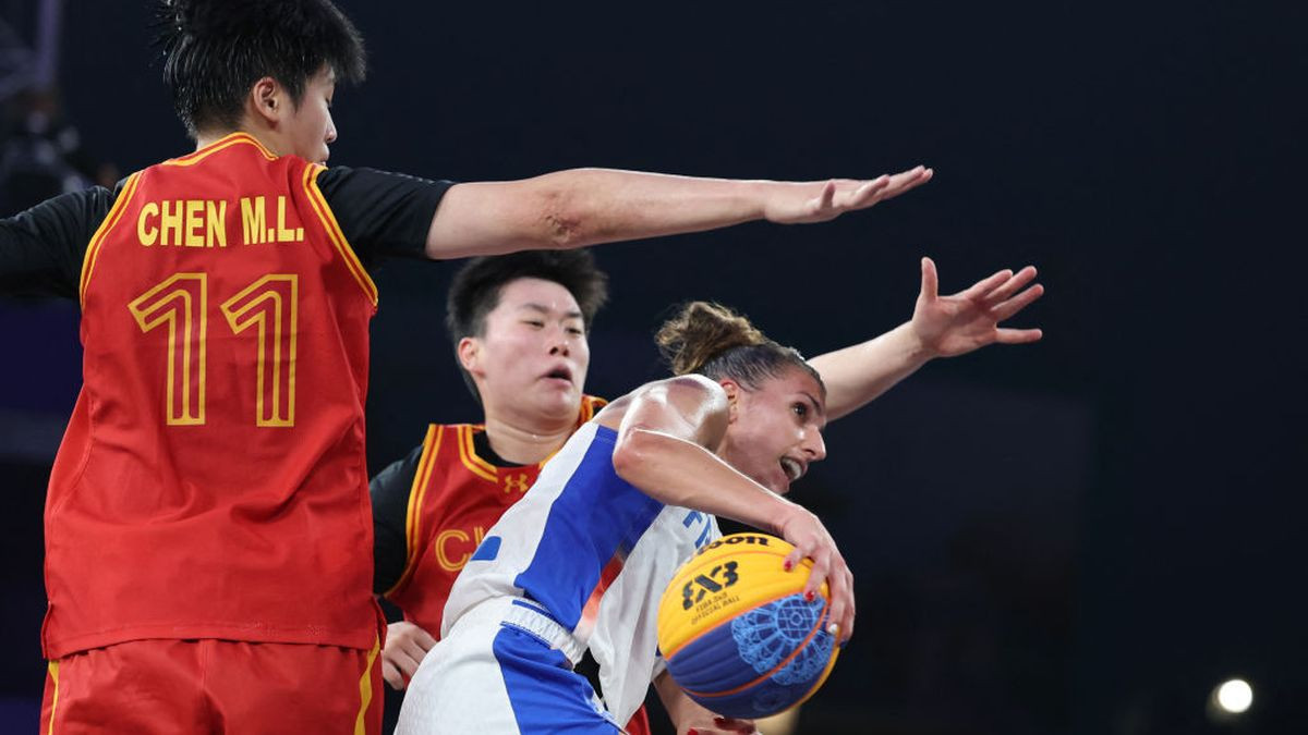 Laetitia Guapo from France looks to pass past China's #11 Chen Mingling in the women's game. GETTY IMAGES