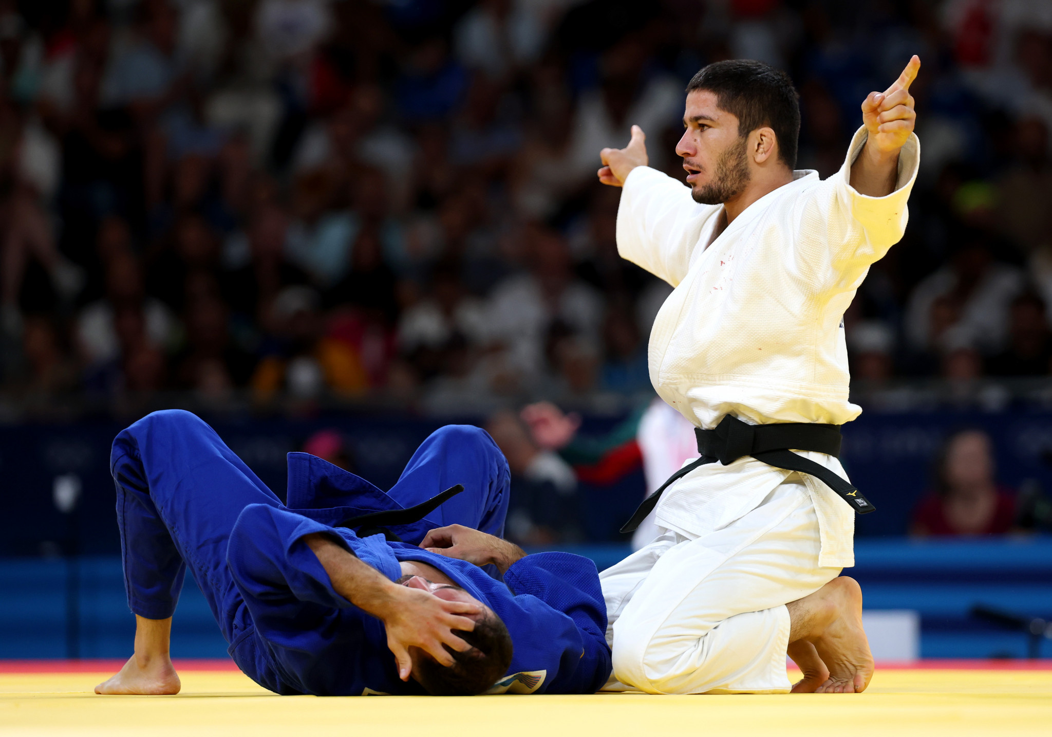 Nurali Emomali of Team Tajikistan and Baruch Shmailov of Team Israel at the Paris 2024 Olympic Games. GETTY IMAGES
