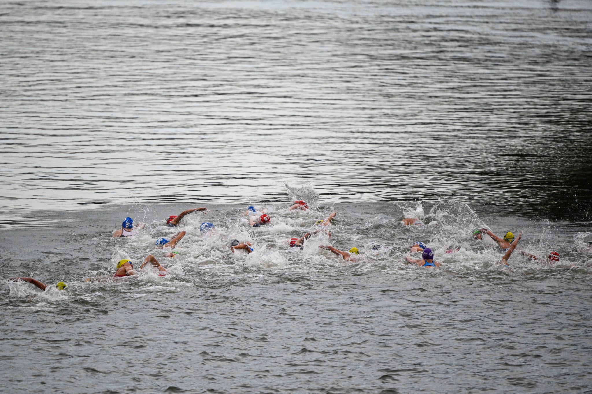 Athletes swim in th Seine during the women's individual triathlon. GETTY IMAGES