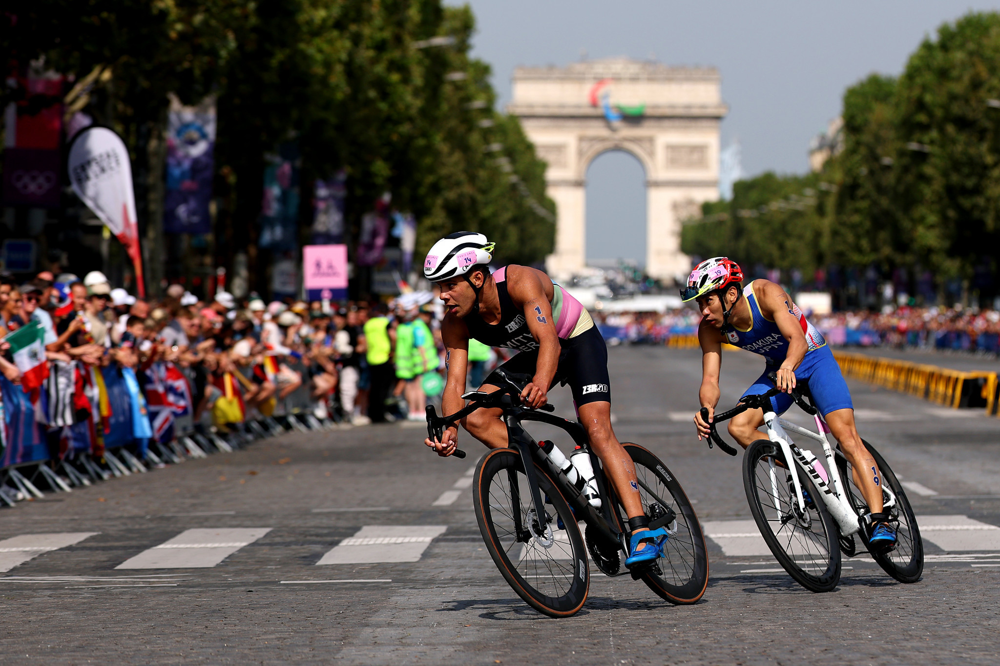 Athletes riding with the Arc de Triomphe in the background. GETTY IMAGES