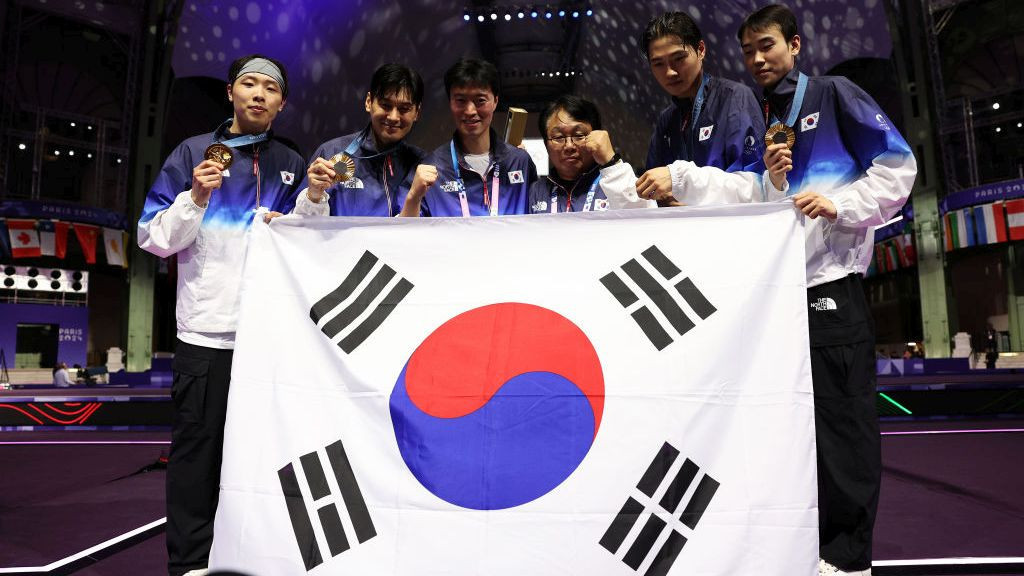 Team Korea celebrate off the podium during the Men's Sabre Team medal. GETTY IMAGE