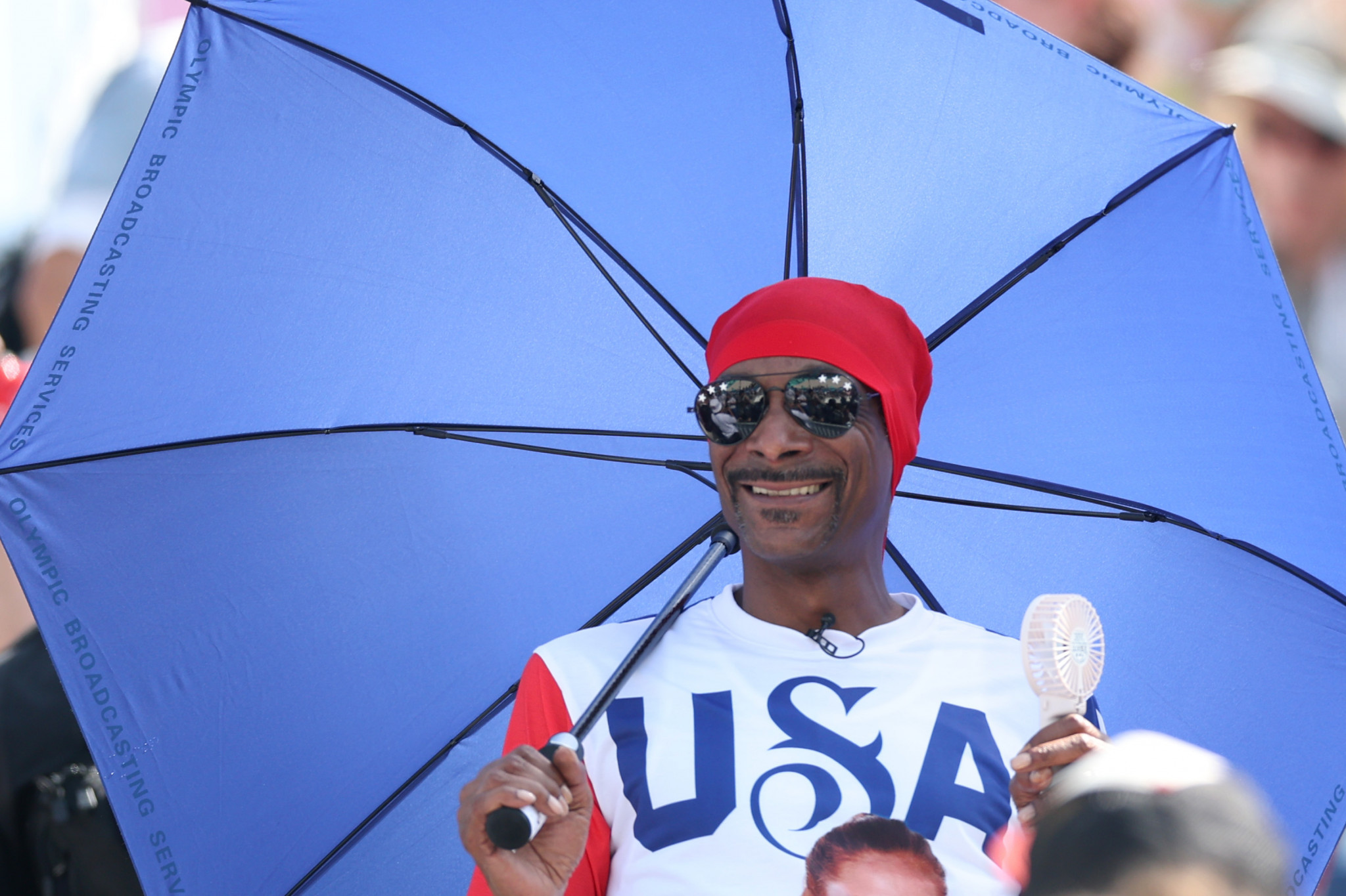 Snoop Dogg sheltering from the sun while watching a Team United States beach volleyball match at the Paris 2024 Olympic Games. GETTY IMAGES