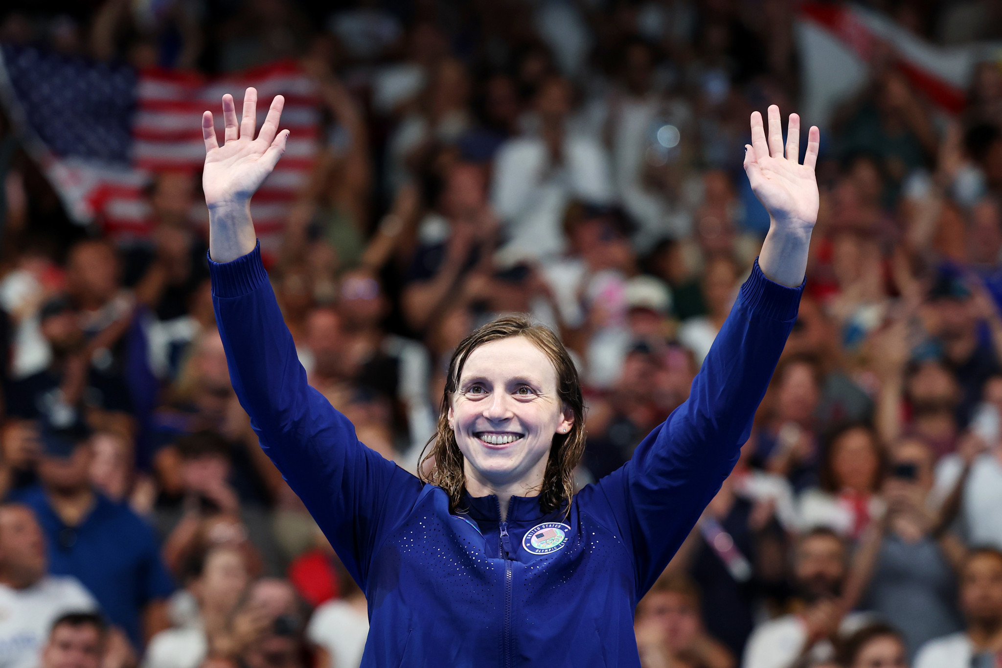 Gold Medalist Katie Ledecky of Team United States waves at fans from the podium after winning the Women's 1500m Freestyle Final at the Paris 2024 Olympic Games. GETTY IMAGES
