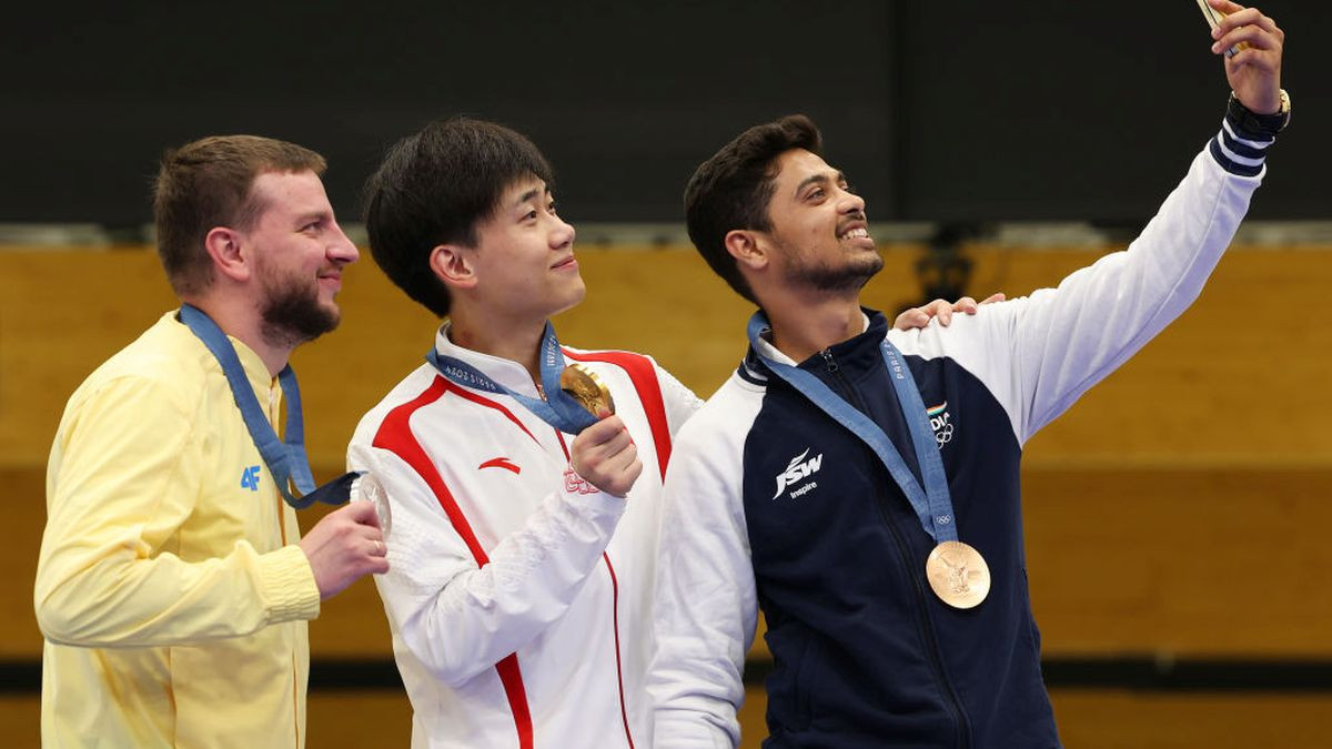 Gold medalist Yukun Liu of China, Silver medalist Serhiy Kulish of Ukraine and Bronze Swapnil Kusale of India pose on the podium. GETTY IMAGES